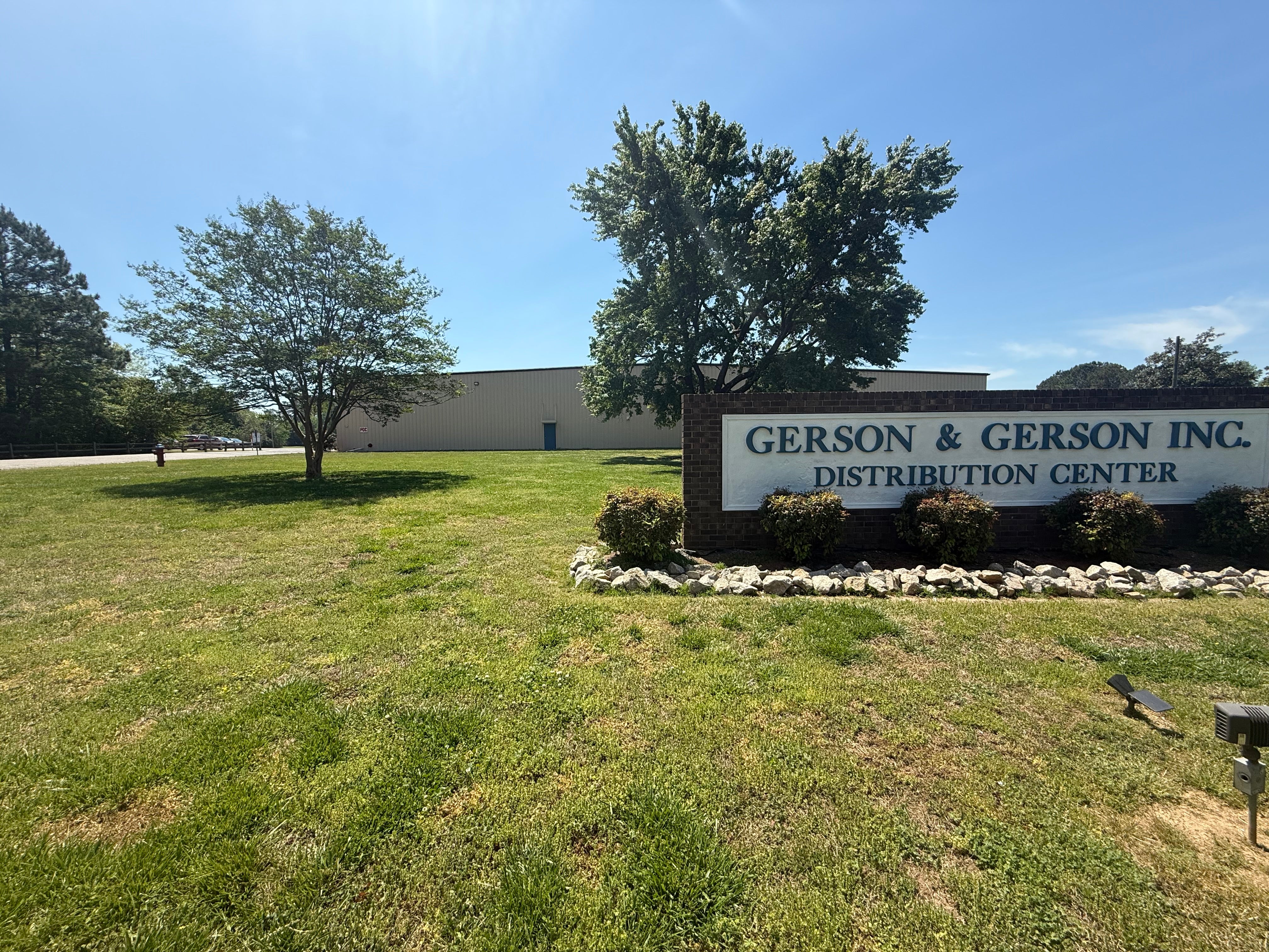 Gerson & Gerson Inc. distribution center sign in front of a building with trees and grass.